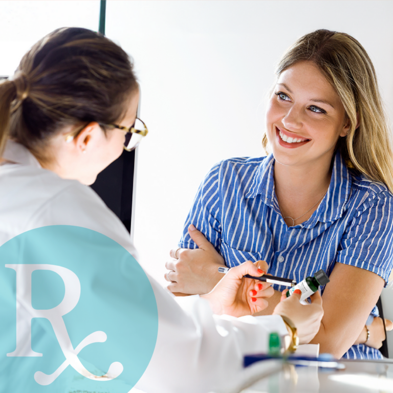 Smiling female patient consulting with a dermatologist about a prescription skincare treatment.