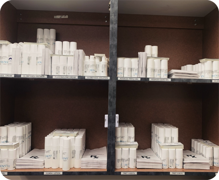 Organized shelves displaying SKNV medications, including creams, gels, and lotions, labeled for easy in-office dispensing