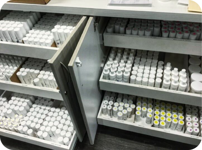 Drawers stocked with SKNV medications, featuring a variety of bottles and organized compartments for in-office dispensing.